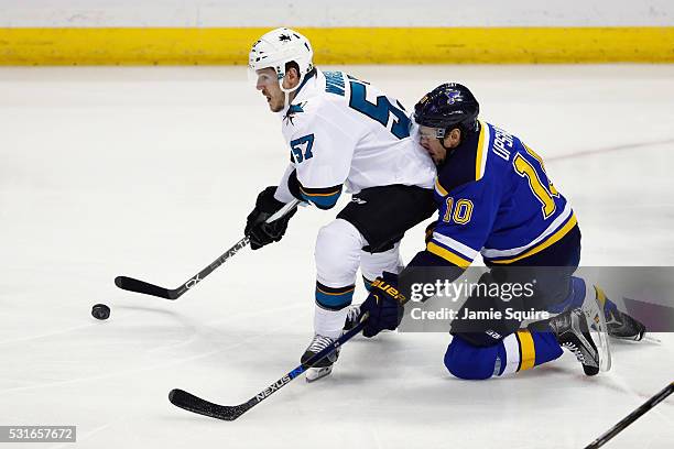 Scottie Upshall of the St. Louis Blues collides with Tommy Wingels of the San Jose Sharks during the first period in Game One of the Western...