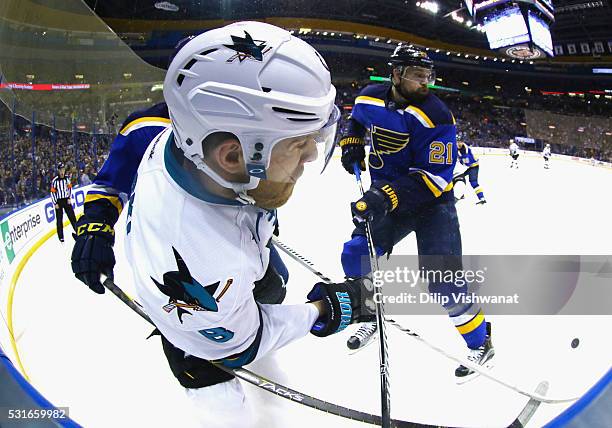 Joe Pavelski of the San Jose Sharks battles for the puck with Joel Edmundson of the St. Louis Blues and Patrik Berglund during the second period in...