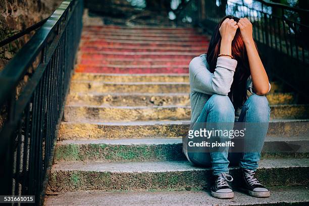 lonely teenager crying outdoors - family problems stock pictures, royalty-free photos & images