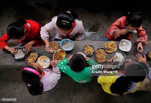 Students eat free lunch at Yuanbao school of Longli country on May 13 in Guizhou, China. Guizhou is a mountainous province located in the southwest...