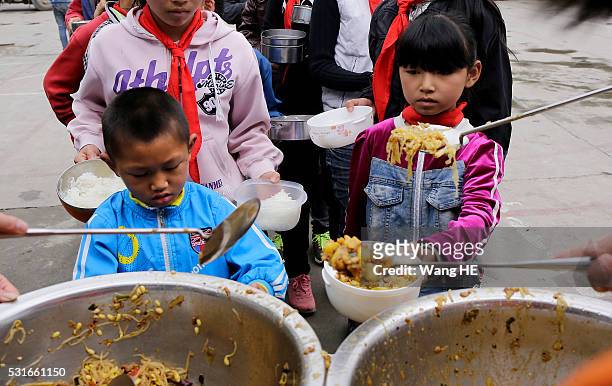 Students queue for free lunch at Yuanbao school of Longli country on May 13 in Guizhou, China. Guizhou is a mountainous province located in the...