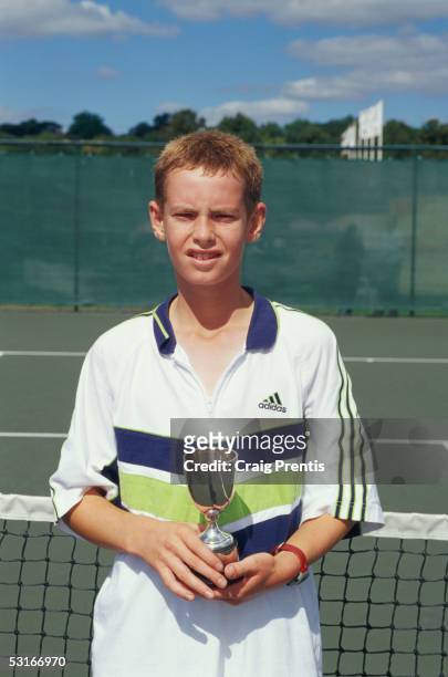 Andrew Murray poses with the trophy after winning the Under 14s event during the National Junior Championships at the Nottingham tennis centre on...