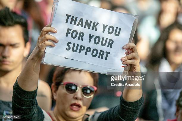 Brazilian woman holds a banner during a rally against interim President Michel Temer in Sao Paulo, Brazil on May 16, 2016. Temer vice president in...