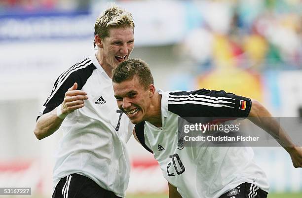 Bastian Schweinsteiger and Lukas Podolski of Germany celebrates the score to the first goal during the game between germany and Mexico for the third...