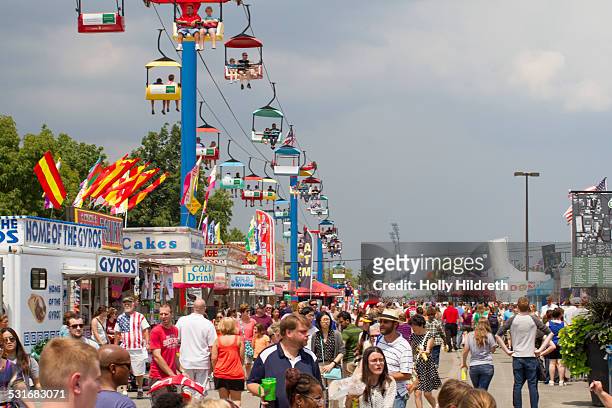 Visitors flood the midway at the Ohio state fair. States in the Midwest take particular pride in their state fairs, and they're often considered THE...