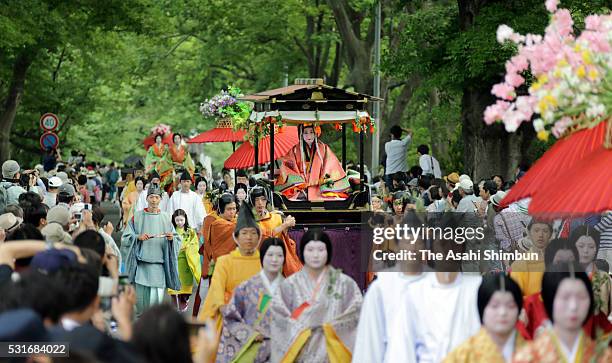 The 'Saio-dai' queen, principle figure of festival wearing a 12-layered ceremonial kimono of Heian Period court ladies called Junihitoe, marches on...