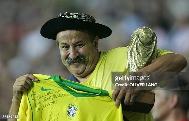 Germany: A Brazilian supporter celebrates with a mock trophy after his team defeated Argentina by 4-1 in the 2005 FIFA Confederations Cup football...