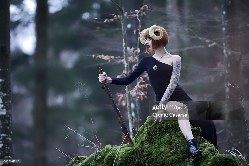 Aries woman portrait in the wild woods