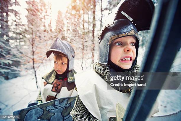 little knights quest in frozen winter forest - charming stock pictures, royalty-free photos & images