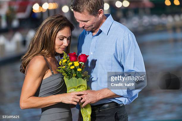 mature, romantic couple with bouquet of flowers - kali rose stock pictures, royalty-free photos & images