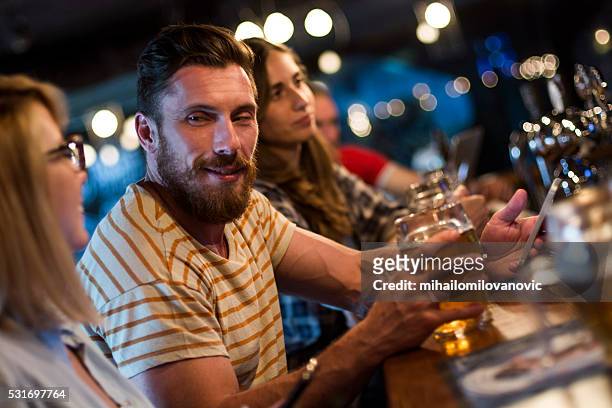 group of friends having fun at the bar - flirting stockfoto's en -beelden