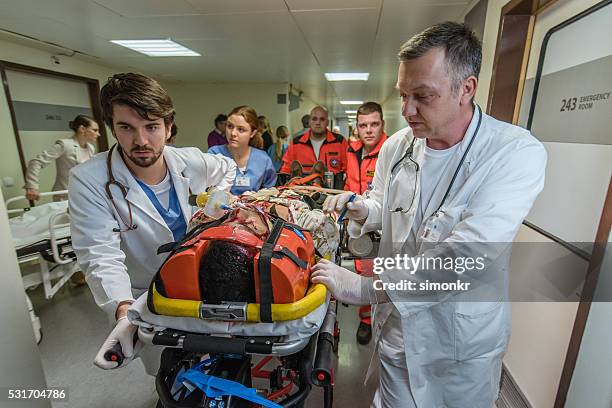 paramedics and doctors in hospital - hospital-emergency stock pictures, royalty-free photos & images