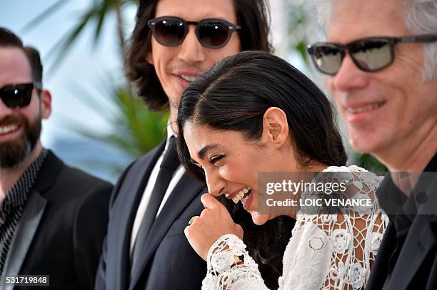 French-Iranian actress Golshifteh Farahani laughs as she poses on May 16, 2016 with US actor Adam Driver and US director Jim Jarmusch during a...