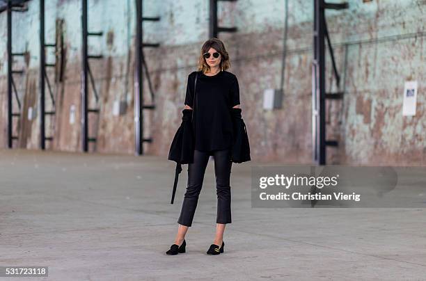 Talisa Sutton wearing black Ray Ban sunglasses, a black top with oversized sleeves a black 7 8 leather pants, black Gucci bag, black Gucci mid-heel...