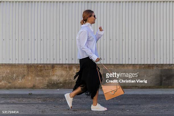 Lisa Hamilton wearing a white Asos button shirt, white choker, a black Finders Keepers skirt with fringes, white Adidas sneakers and a beige Chloe...