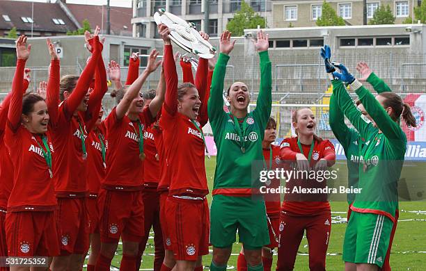 The Bayern Muenchen women team celebrate their German Championship title holding up the trophy after the women Bundesliga match between FC Bayern...