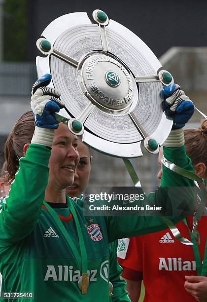 Goalkeeper Tinja-Riikka Korpela of Bayern Muenchen holds up the German Championship trophy after the women Bundesliga match between FC Bayern...