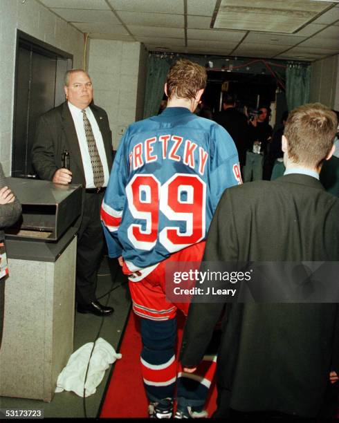 Canadian hockey player Wayne Gretzky, forward of the New York Rangers, walks back onto the ice for an encore after his final professional hockey...