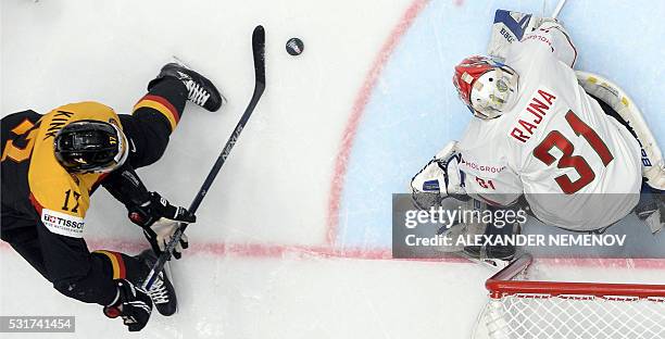 Germany's forward Marcus Kink attacks Hungary's goalie Miklos Rajna during the group B preliminary round game Germany vs Hungary at the 2016 IIHF Ice...