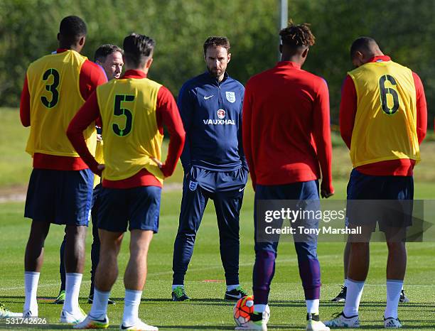 Manager Gareth Southgate talks with his players during an England Under 21 training session at St Georges Park on May 16, 2016 in Burton-upon-Trent,...