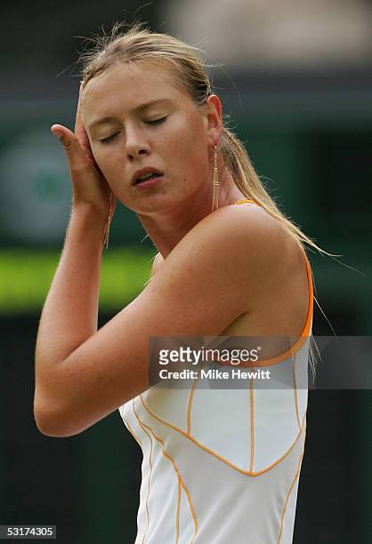 Maria Sharapova of Russia touches her hair against Venus Williams of USA during the tenth day of the Wimbledon Lawn Tennis Championship on June 30,...