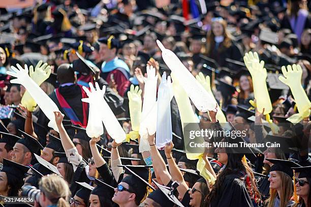 Medical school graduates hold inflated surgical gloves the University of Pennsylvania's 260th Commencement at Franklin Field on May 16, 2016 in...