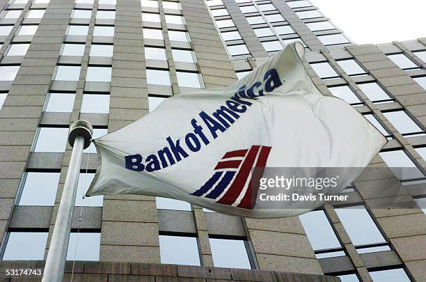 Flag flies outside the Bank of America Corporate Center June 30, 2005 in downtown Charlotte, North Carolina. Bank of America, which has its corporate...