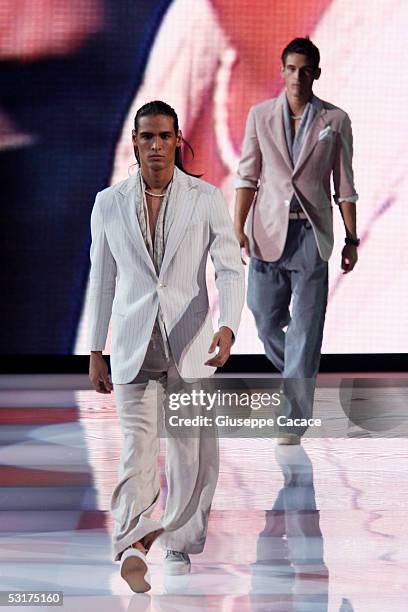 Models walk down the runway at Giorgio Armani show as part of Milan Menswear Week Spring/Summer 2006 on June 30, 2005 in Milan, Italy.