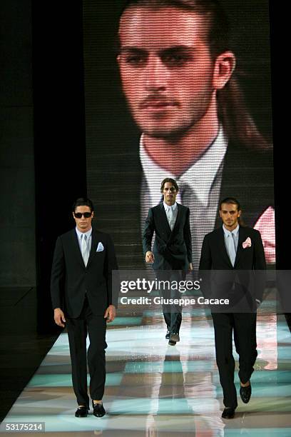 Models walk down the runway at Giorgio Armani show as part of Milan Menswear Week Spring/Summer 2006 on June 30, 2005 in Milan, Italy.