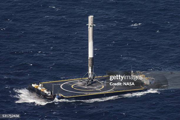 In this handout provided by the National Aeronautics and Space Administration , SpaceX's Falcon 9 rocket stands after making its first successful...