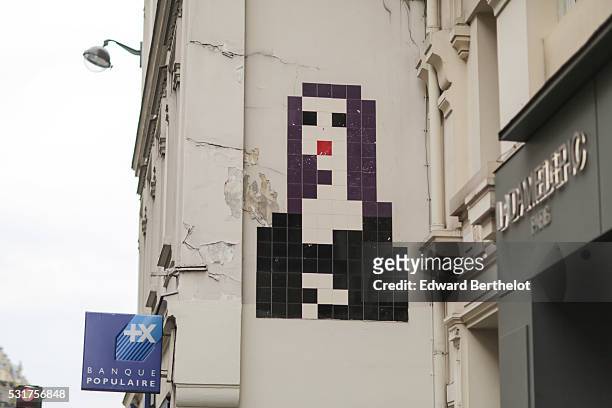 Street art graffiti is seen, representing Mona Lisa La Joconde made of pixels, at Louvre Rivoli, in the 1st quarter of Paris, on May 16, 2016 in...