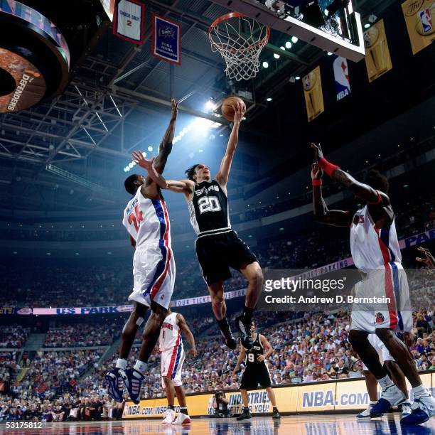 Manu Ginobili of the San Antonio Spurs goes for a layup against Antonio McDyess and Ben Wallace of the Detroit Pistons in Game Five of the 2005 NBA...
