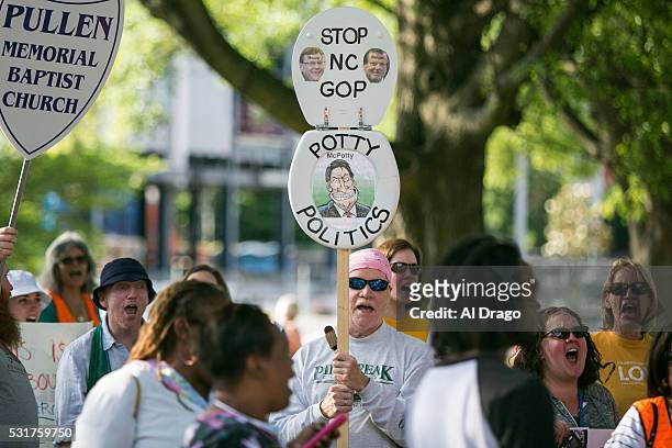 Protestors gather across the street from the North Carolina state legislative building as they voice their concerns over House Bill 2, in Raleigh,...
