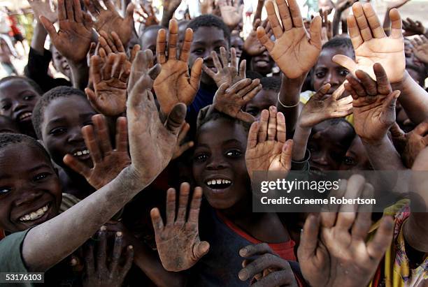 Children wave to the media as they gather together June 30, 2005 in Mozambique. Since Mozambique's 15-year civil war ended in 1992, the country has...