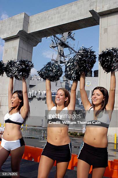 Philadelphia Eagles cheerleaders cheer as the USS Cole enters port June 30, 2005 in Philadelphia, Pennsylvania. The USS Cole, which was heavily...