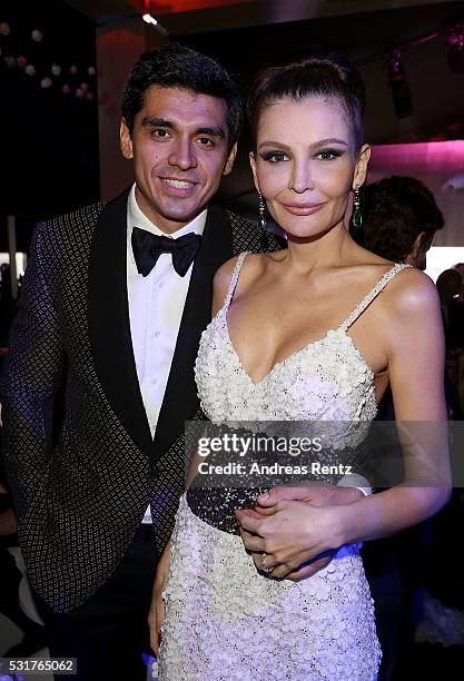 Timur Tillyaev and wife Lola Karimova-Tillyaeva attend The Harmonist Cocktail Party during The 69th Annual Cannes Film Festival at Plage du Grand...