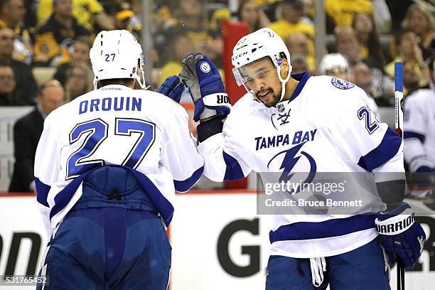 Jonathan Drouin of the Tampa Bay Lightning celebrates with his teammate J.T. Brown after scoring a goal against Matt Murray of the Pittsburgh...