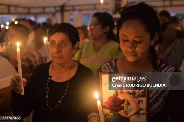 Local residents participate in a mass officiated in a public square, in Pedernales, Ecuador, on May 16, 2016. A total of 660 people are now known to...