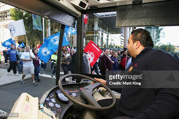 Bus driver is held up in traffic as New South Wales workers march towards the Sydney Harbour Bridge after attending Australia's largest ever workers'...