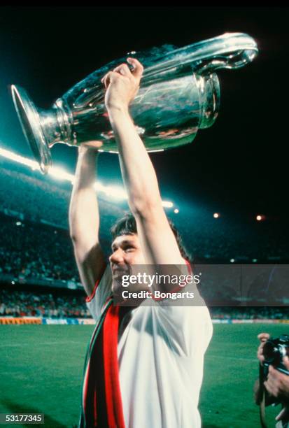 Marco Van Basten of AC Milan celebrates with the trophy after winning the European Cup Final match against Steaua Bucuresti at Nou Camp in Barcelona,...