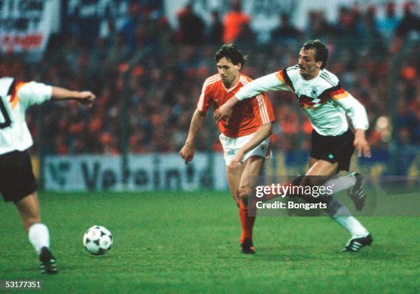 Marco Van Basten of Netherlands and Juergen Kohler of Germany struggle for the ball during the FIFA 1990 World Championship qualification match De...