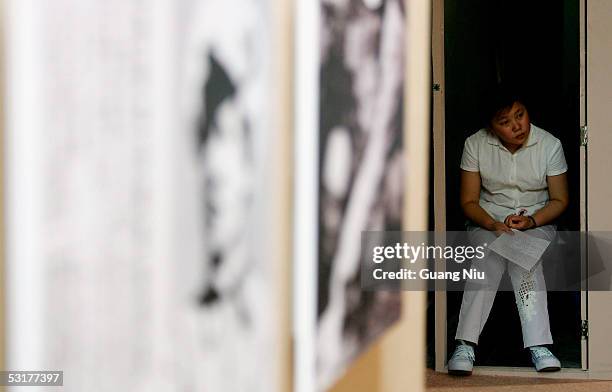 An attendant works at an exhibition to commemorate the 60th anniversary of the victory against Japanese occupation during World War II on July 1,...