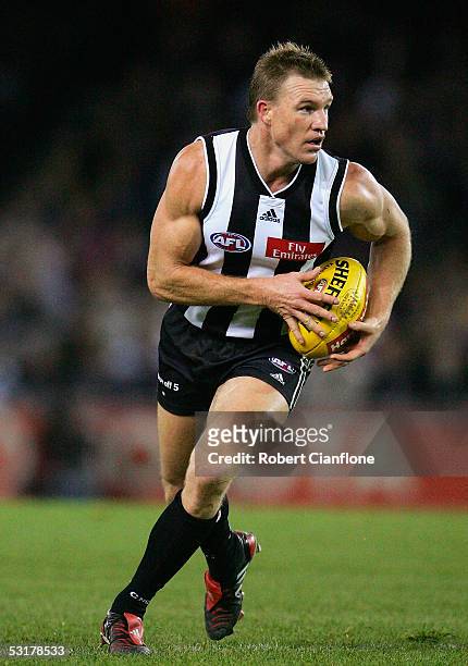 Nathan Buckley of the Magpies in action during the round 14 AFL match between the Collingwood Magpies and Port Adelaide Power at the Telstra Dome on...
