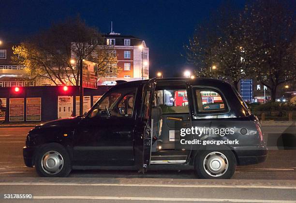 black london cab waiting on the street - black cab stock pictures, royalty-free photos & images