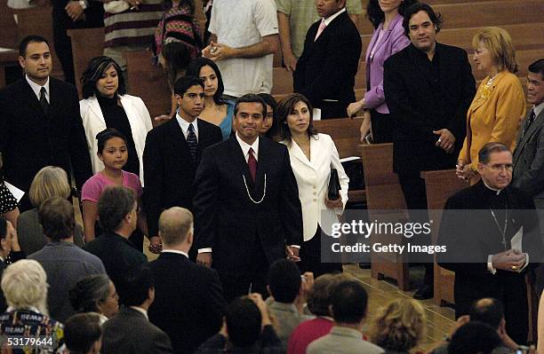 Incoming Los Angeles Mayor Antonio Villaraigosa and his family follow Cardinal Roger Mahony to their seats at the start of the interfaith prayer...