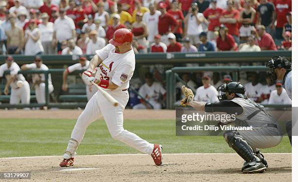 Outfielder Larry Walker of the St. Louis Cardinals swings at a pitch against the Pittsburgh Pirates during the MLB game at Busch Stadium on June 26,...