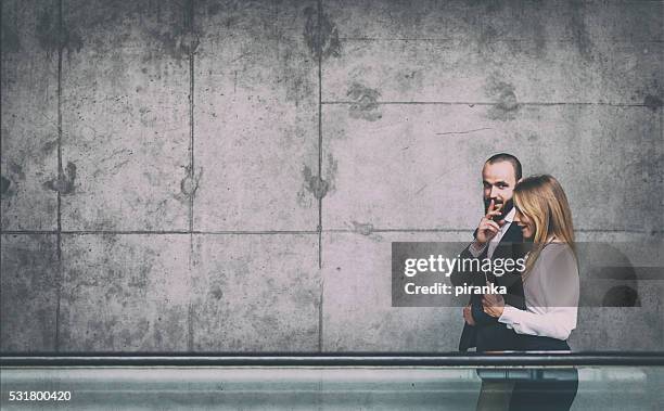 business gossip - woman with finger on lips stock pictures, royalty-free photos & images