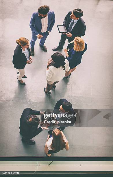 overhead view of a group of business people - overhead view of meeting stock pictures, royalty-free photos & images