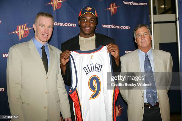 Vice President of Basketball Operations Chris Mullin, Ike Diogu, and head coach Mike Montgomery of the Golden State Warriors pose on June 30, 2005 at...