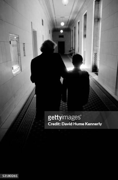 Supreme Court justice Sandra Day O'Connor walks a young visitor through the Supreme Court Corridor in Washington, DC June 14, 1996.